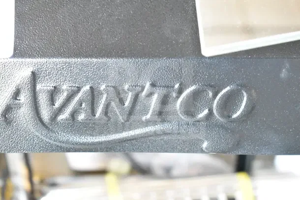 Avantco brand logo imprint on a heated display case. Model 177HDC26. Embossed text on a textured surface.