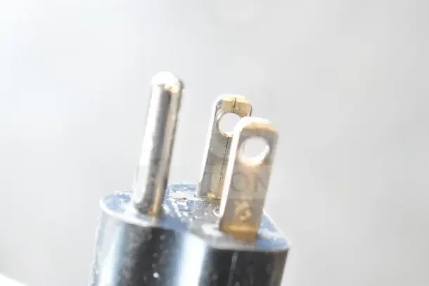 Close-up of a 3-prong US plug for the 2026 Cadco Lisa OV-013 convection oven, showcasing electrical compatibility.