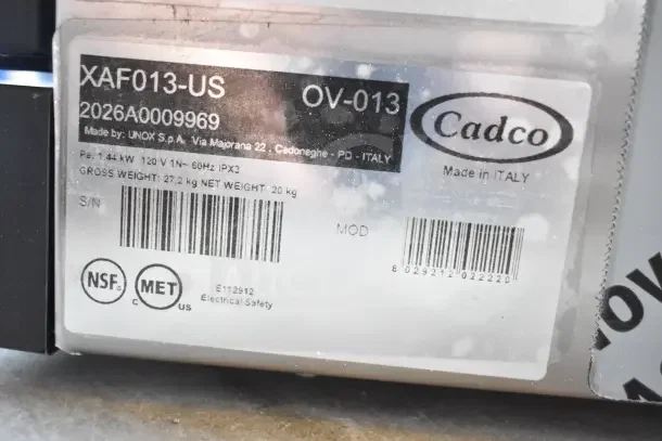 Alt text: "Cadco Lisa OV-013 convection oven label, showing model, power specs, and safety certifications. Made in Italy."