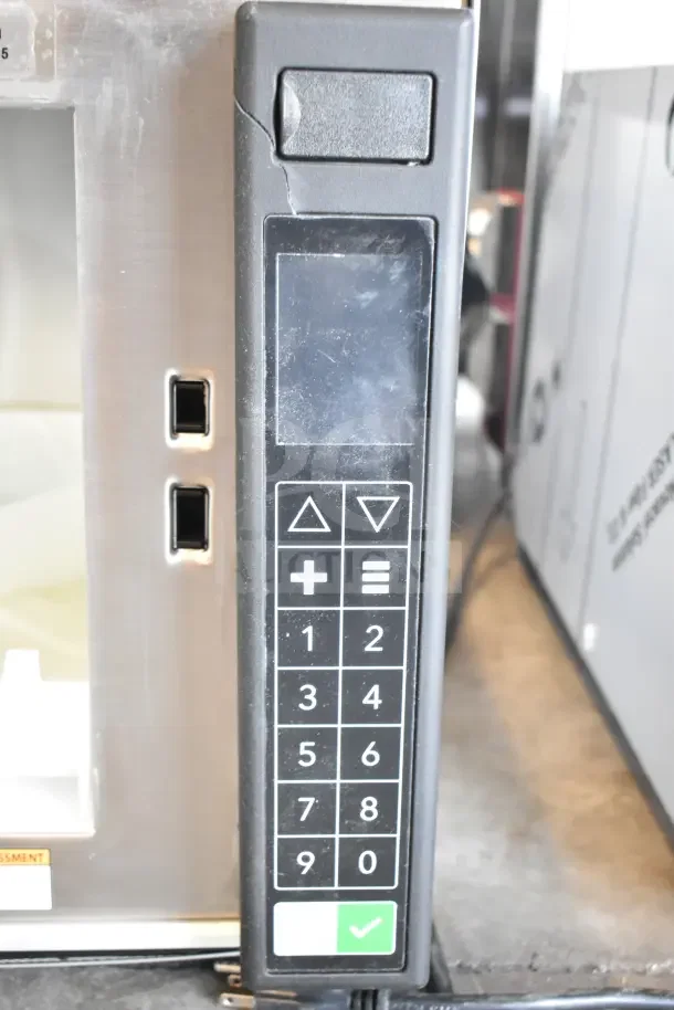 BRAND NEW SCRATCH AND DENT! Amana RC17S2 Heavy Duty Stainless Steel Commercial Microwave with push button controls, visible exterior crack.