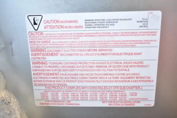 BRAND NEW Amana RC17S2 heavy-duty stainless steel commercial microwave, 208/240V, scratch and dent, with warning label.