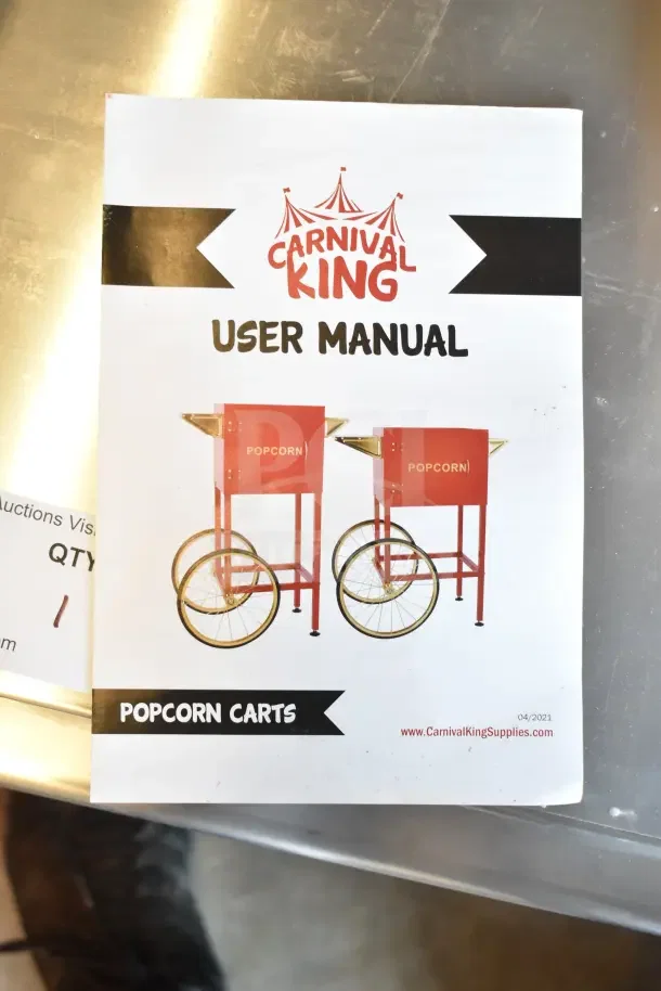Carnival King user manual for popcorn carts on a metal surface, showing two red popcorn carts with large wheels.
