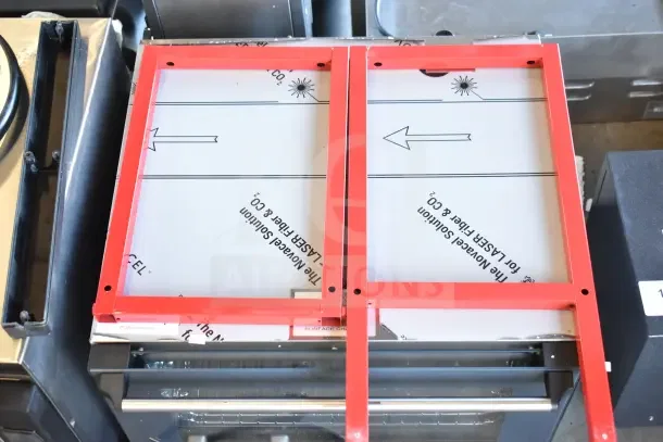 Brand new popcorn cart, scratch and dent. Red frame, protective covering. Laser cut markings visible.