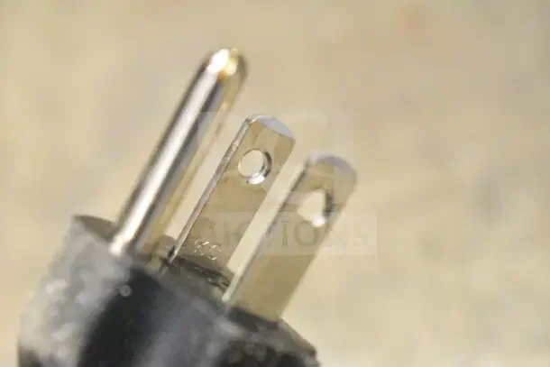 Close-up of a power plug from the 2025 Bunn TB3Q Iced Tea Brewer. The prongs are metallic and new.