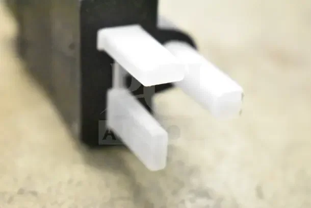 Close-up of Avantco 177CPBTR66B bun toaster plug, showing white prongs. Part of unused commercial toaster.
