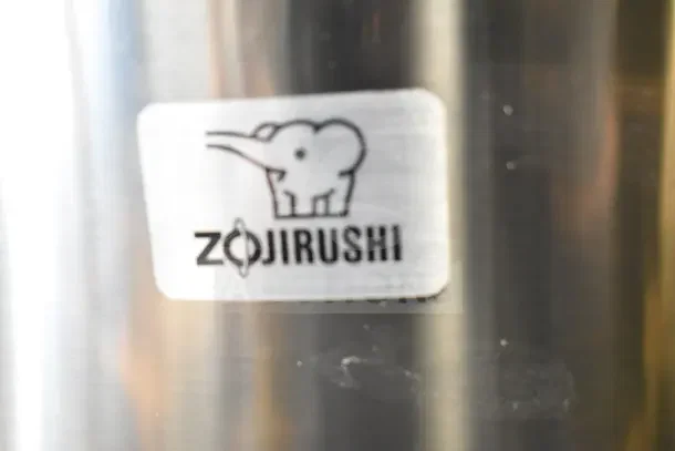 Zojirushi THA-803S stainless steel electric rice warmer with logo, 88-cup capacity, 120 volts, new condition with scratches.