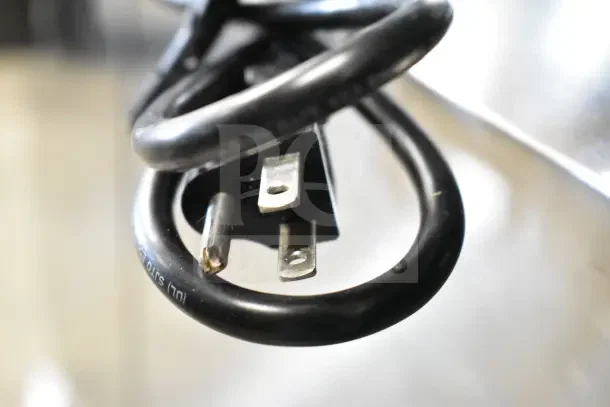 A close-up image of the power cord from the Zojirushi THA-803S rice warmer, showing its UL certification and standard plug.