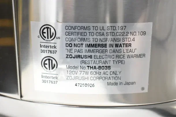 Stainless steel Zojirushi Electric Rice Warmer, model THA-803S, 88 cup capacity. Label shows compliance certifications.