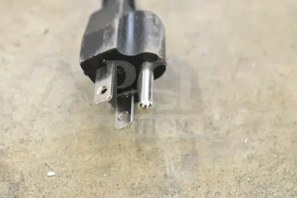 Close-up of a power plug for a Galaxy 177CRG3B refrigerated merchandiser, showing standard three-prong design.