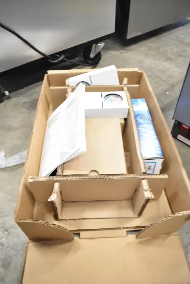 Brand new Hatco C-13 compact booster water heater, 240 volts, 1 phase, shown in packaging with manuals and components.