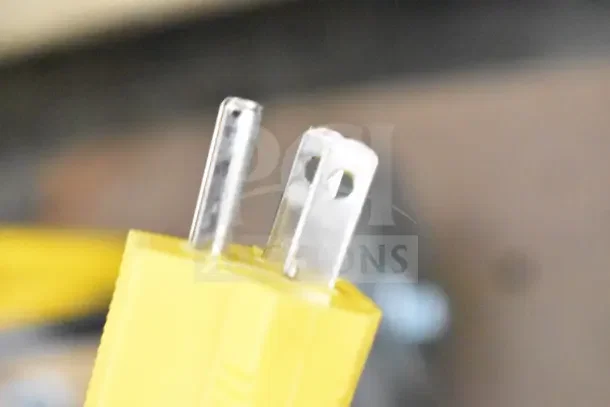Close-up of yellow electrical plug for Lavex Pro 978LPS20BDC Burnisher. Item is brand new with scratches and dents.