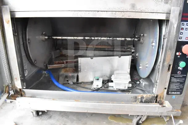 2 Hardt Inferno GC/4000 commercial rotisserie ovens on casters, natural gas powered, 68,000 BTU, visible wear.