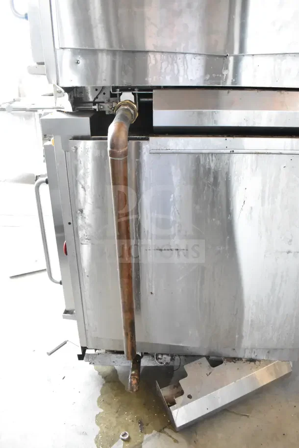 Hardt Inferno GC/4000 rotisserie oven on casters, natural gas powered, 68,000 BTU, visible wear, pipes and metal exterior.