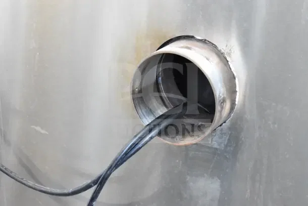 Close-up of Hardt Inferno GC/4000 rotisserie oven's utility connection, showing cables through a metal fitting.