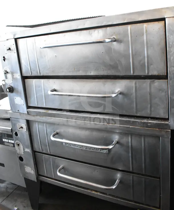 Bakers Pride commercial gas pizza oven, single deck, metal legs, stainless steel, visible wear, branded handles.