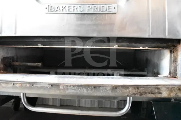 Bakers Pride commercial gas pizza oven, single deck, metal legs, visible wear, brand plate shown.