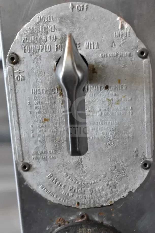 Control dial on Bakers Pride commercial gas pizza oven showing settings and instructions in used condition.