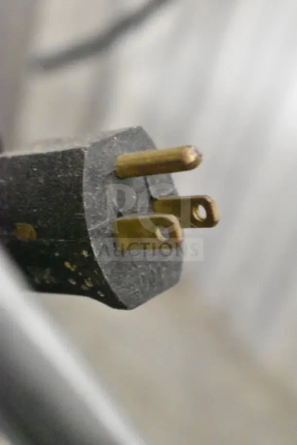 Close-up of a three-prong plug for the Hobart A200 mixer. 115 volts, 1 phase, shown in used condition.