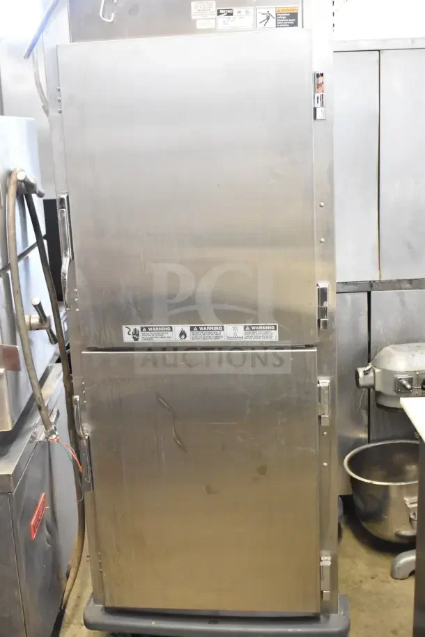 Metro C599-SDS-LPDSA heated holding cabinet, stainless steel, on commercial casters, 120V, 1 Phase, visible warning labels.