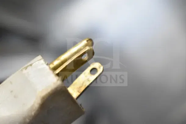Close-up of a standard plug with two prongs, connected to the Metro C599-SDS-LPDSA Commercial Heated Holding Cabinet, showing detail of the connectors.