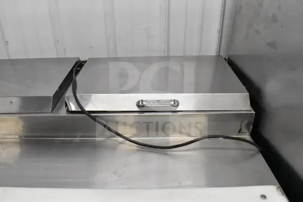 True TPP-67 Pizza Prep Table with commercial casters, stainless steel, 115V, 1 Phase, visible logo and cable.