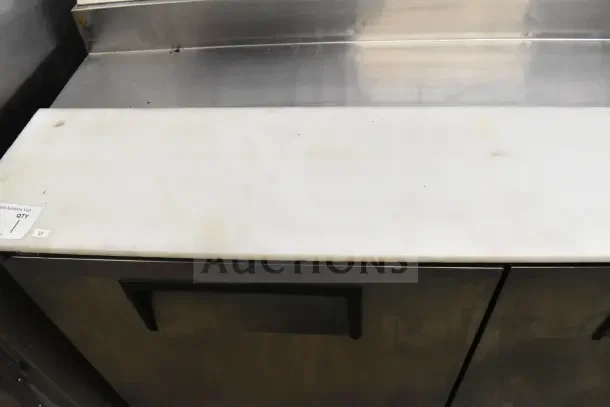 True TPP-67 commercial pizza prep table on casters, stainless steel, 115 volts, 1 phase, visible wear.