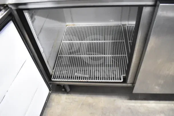 True TPP-67 Commercial Pizza Prep Table, stainless steel, on casters, shows interior shelving, 115V, 1 Phase.