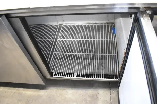 True TPP-67 commercial pizza prep table with interior wire shelving, stainless steel construction, on casters, 115V, 1 Phase.