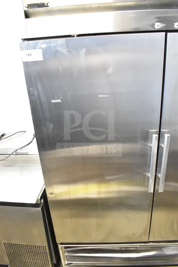 True TS-49 commercial 2-door reach-in cooler on casters, stainless steel finish, 115 volts, 1 phase, minor surface marks.