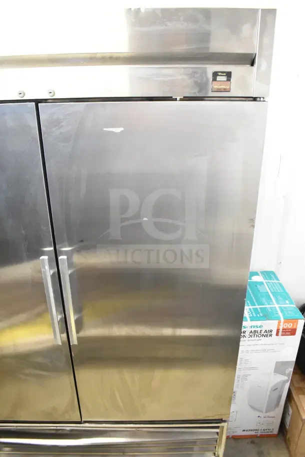 True TS-49 commercial 2-door reach-in cooler on casters, stainless steel finish, 115 volts, 1 phase, minor surface marks.