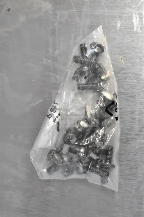 A clear plastic bag containing various screws and bolts for assembly of Bighorn 24" Mini Ranch Fire Pit.