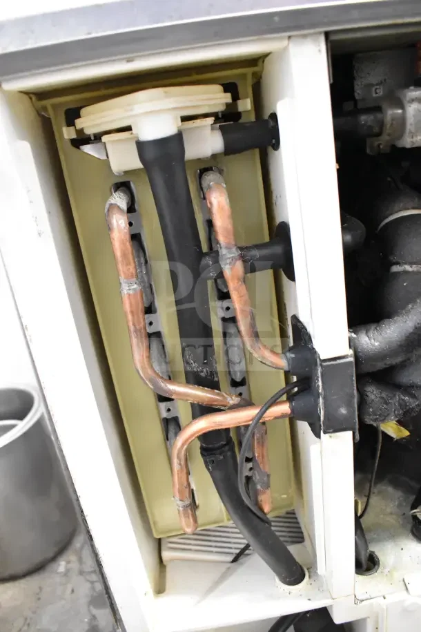 Hoshizaki KM-350MAJ commercial ice machine head, 387lb capacity, 115V, 1 phase. Visible internal copper and rubber tubing.