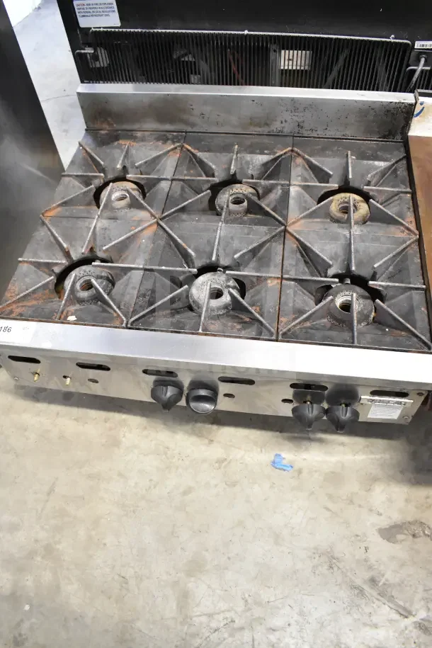 Vulcan Commercial Countertop Gas 6 Burner Range, used condition, stainless steel, visible wear, functional knobs and burners.