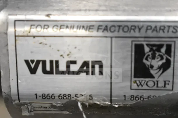 Label on Vulcan Commercial Gas Burner, featuring "Vulcan" and "Wolf" logos. Text: "For Genuine Factory Parts."