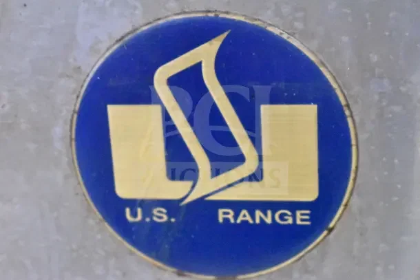 US Range logo on a metal background, featuring a blue and gold design, indicating brand authenticity.