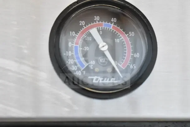 Thermometer dial on True T-19F commercial freezer, showing Celsius and Fahrenheit. NSF certification visible.
