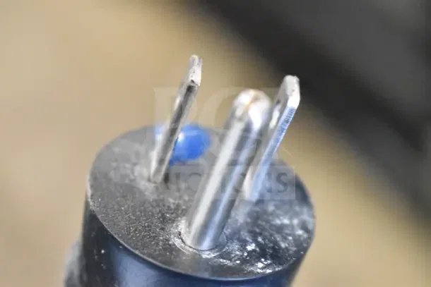 Close-up of a power plug for a 2017 True T-19F commercial freezer, showing prongs and some wear.