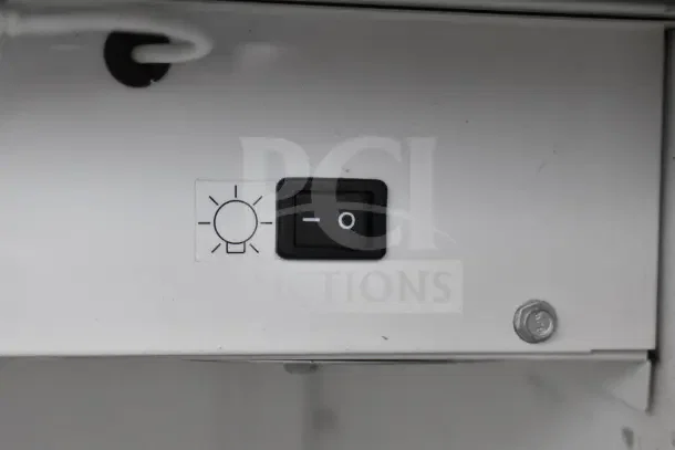 2016 True GDM-10-LD single door cooler light switch, with bulb icon and on/off markings.