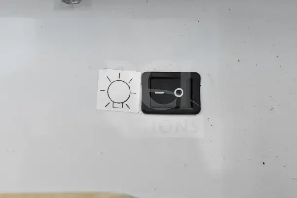 Switch panel of True GDM-12 cooler with a power icon and light bulb symbol, indicating lighting control.
