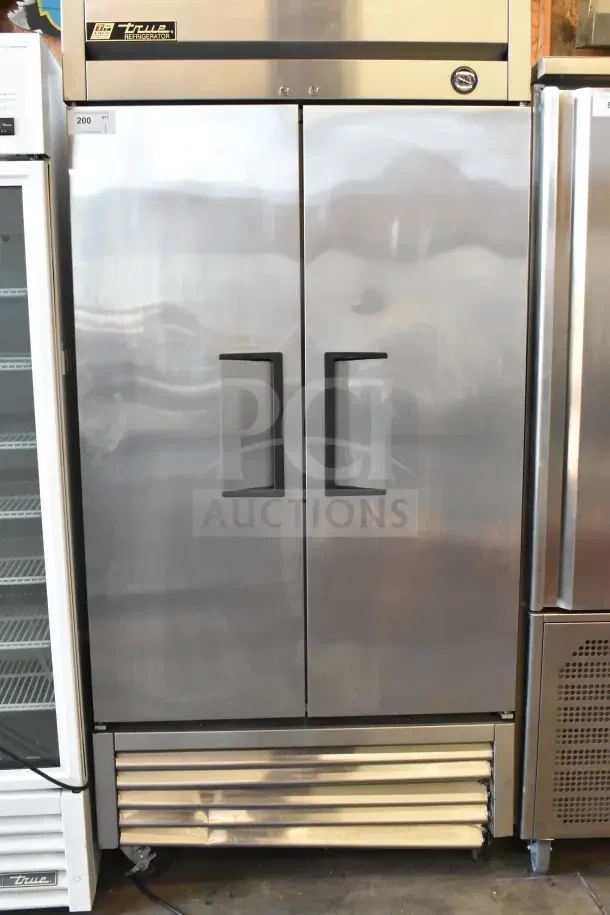 2016 True T-35 commercial 2-door reach-in cooler, stainless steel, on casters, 115V, 1-phase. Minor wear visible.