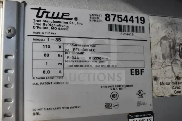 2016 True T-35 commercial cooler label showing model, voltage, refrigerant, compressor details, and certification markings.