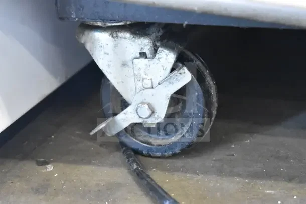 2016 True T-35 commercial cooler caster. Durable metal wheel, used condition, supports cooler mobility.
