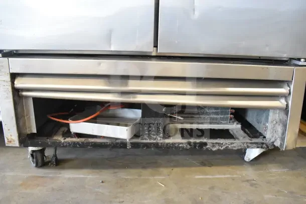 2016 True T-35 commercial 2-door reach-in cooler on casters, 115 volts, 1 phase. Visible wear on exterior, open base panel.