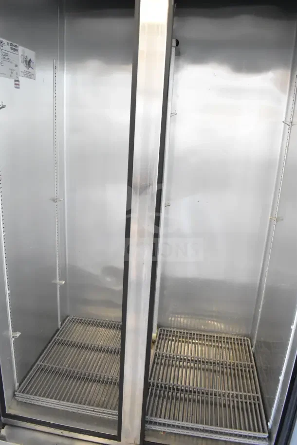 2016 True T-35 commercial 2-door reach-in cooler on casters, 115 volts, 1 phase; features shelves and interior label.
