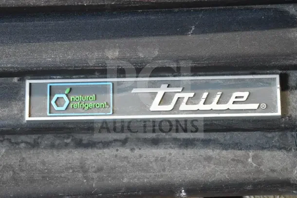 2018 True GDM-72F-HC commercial freezer; logo indicates natural refrigerant use; sturdy 3-door design.