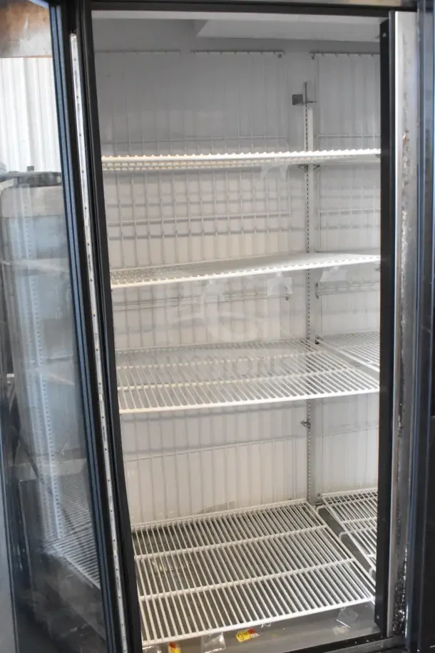 2018 True GDM-72F-HC commercial 3-door reach-in freezer, 115 volts, 1 phase. Glass doors, spacious interior, white shelving.