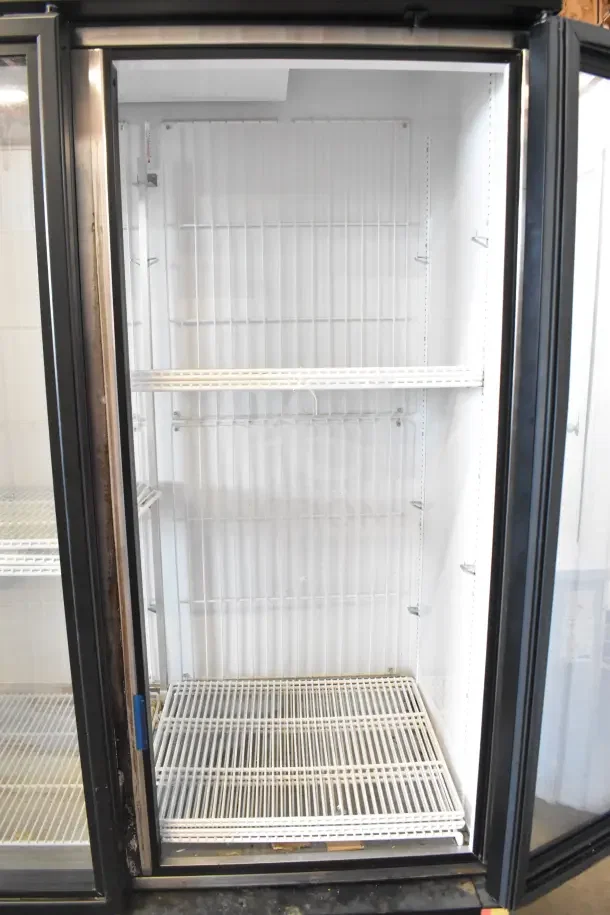 2018 True GDM-72F-HC commercial freezer with 3 glass doors, white interior, adjustable wire shelves, and black exterior.