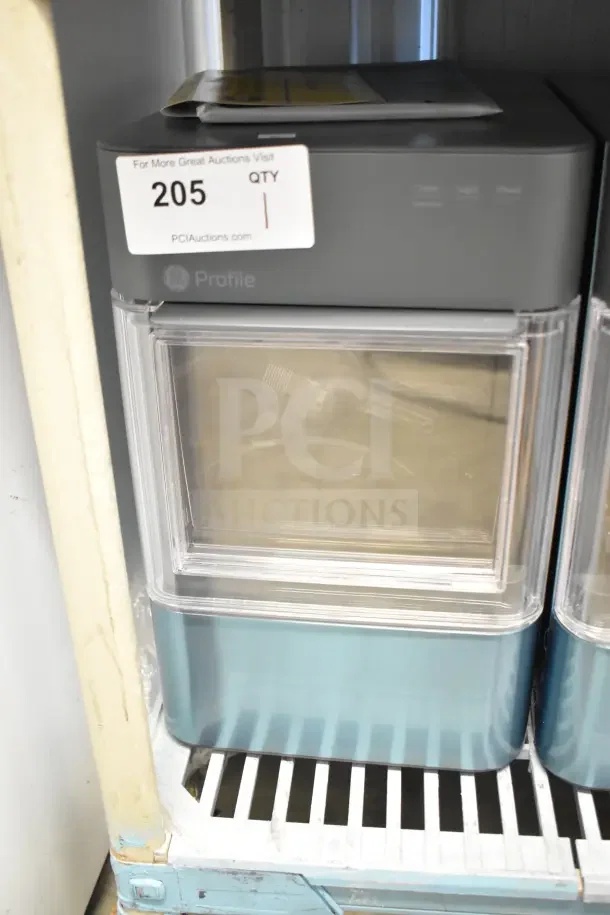 General Electric GE XPIO13SCESS countertop ice maker, 120 volts, 1 phase, with transparent lid and control panel.