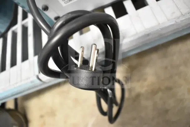 Power cord of a General Electric GE XPIO13SCESS Countertop Ice Maker, 120 Volts, 1 Phase, shown coiled.