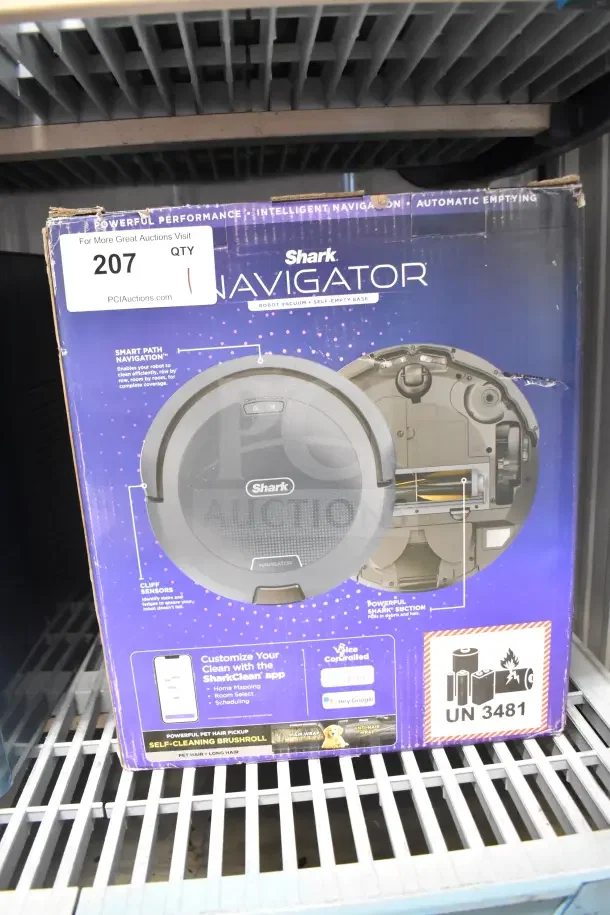 Shark Navigator Robot Vacuum in original box, features smart path navigation and voice control compatibility. Box shows minor wear.